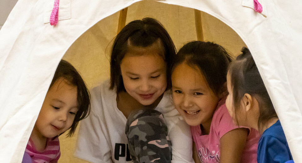 students inside indoor tipi
