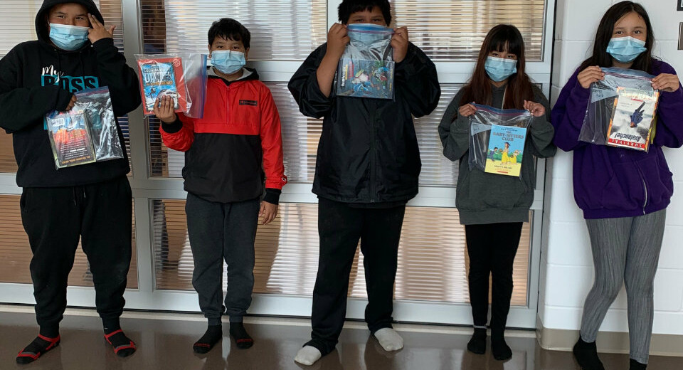 students holding bags with books