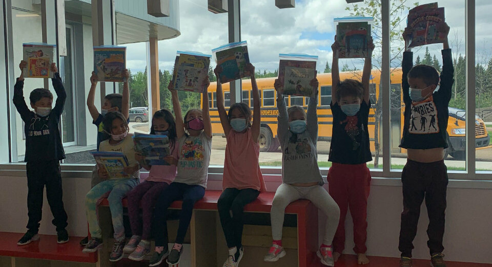 students holding books