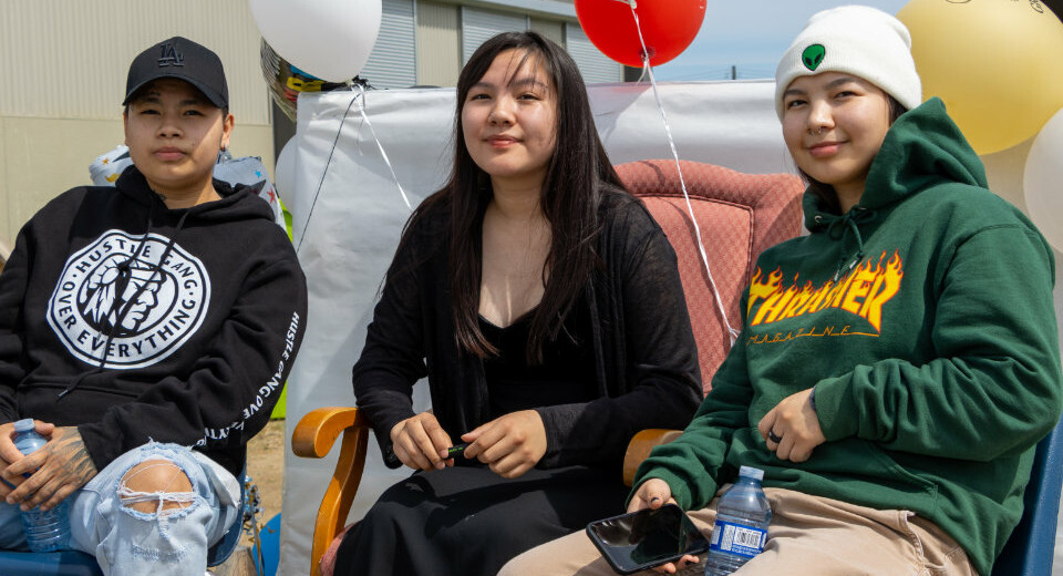 students sitting outside with balloons